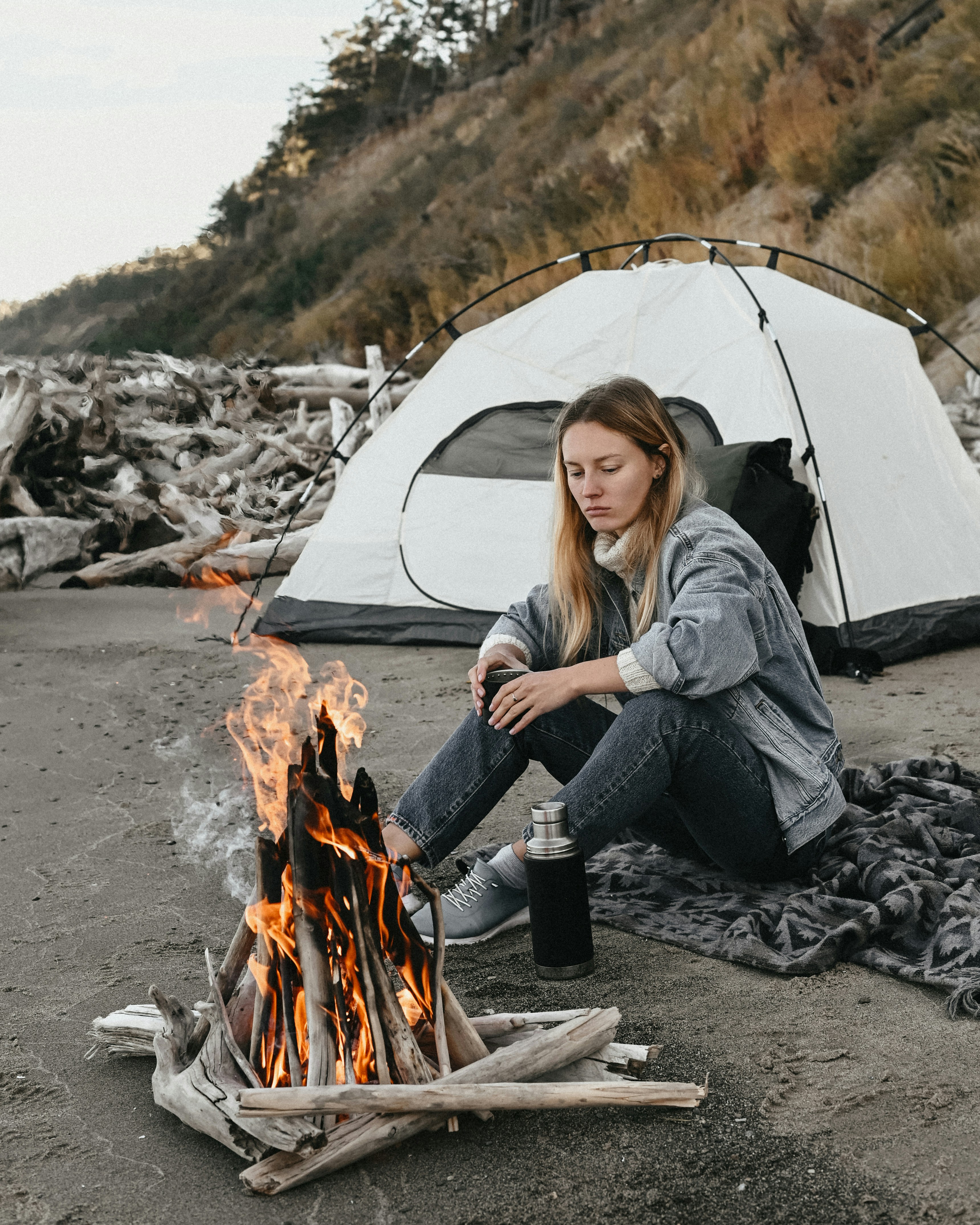 a person sitting next to a campfire