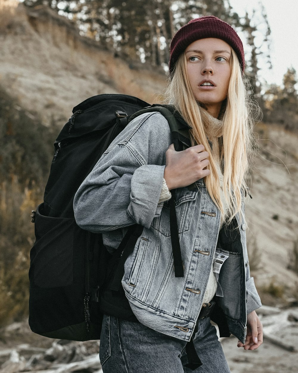 a woman with long hair and a backpack