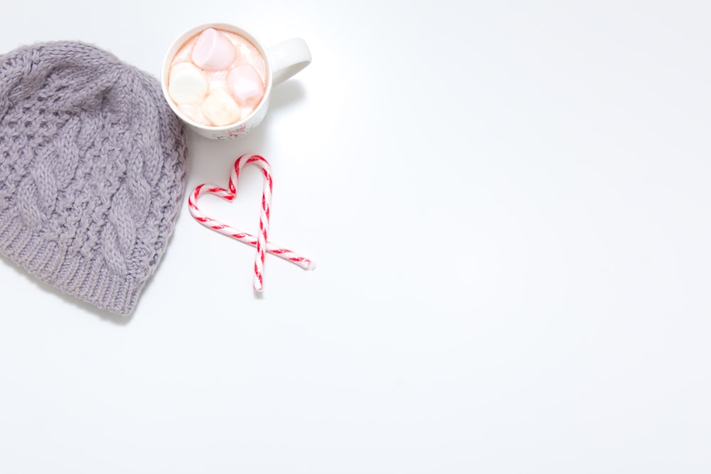 a knitted hat and a cup
