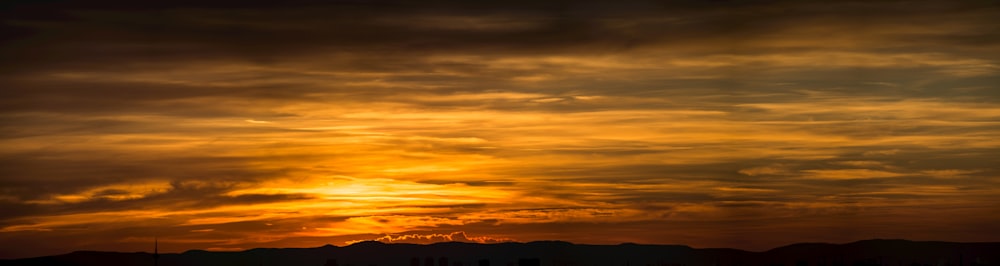 a sunset over a mountain range