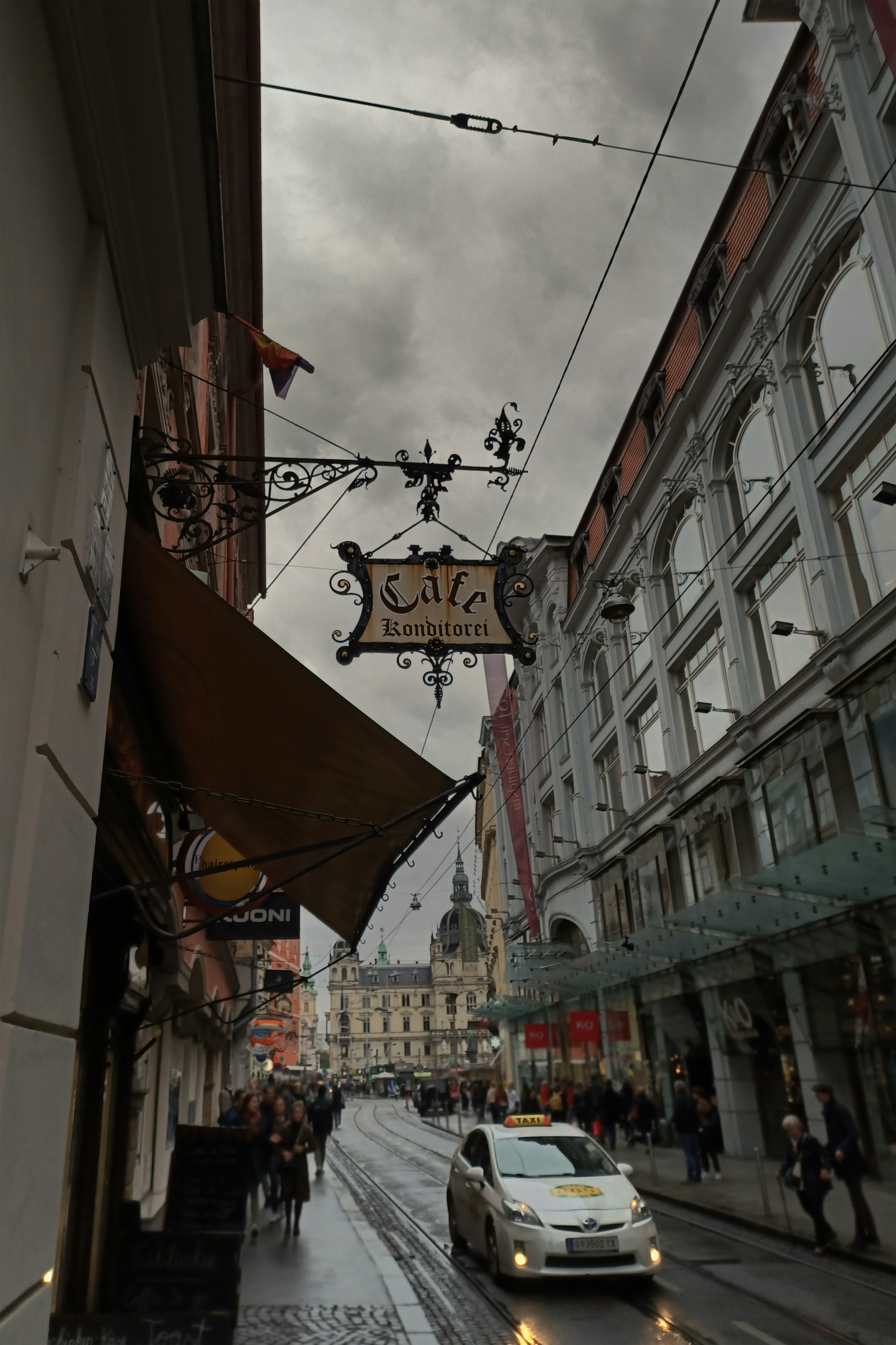 a street with a car and people on it