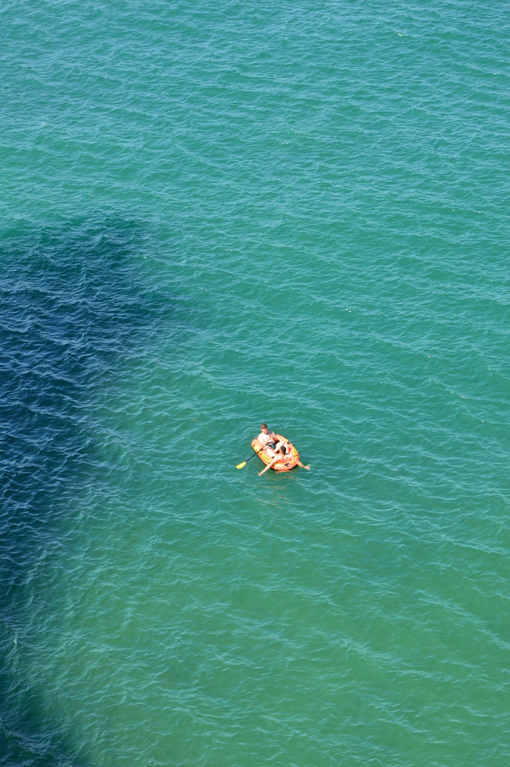 a couple of people on a boat in the water