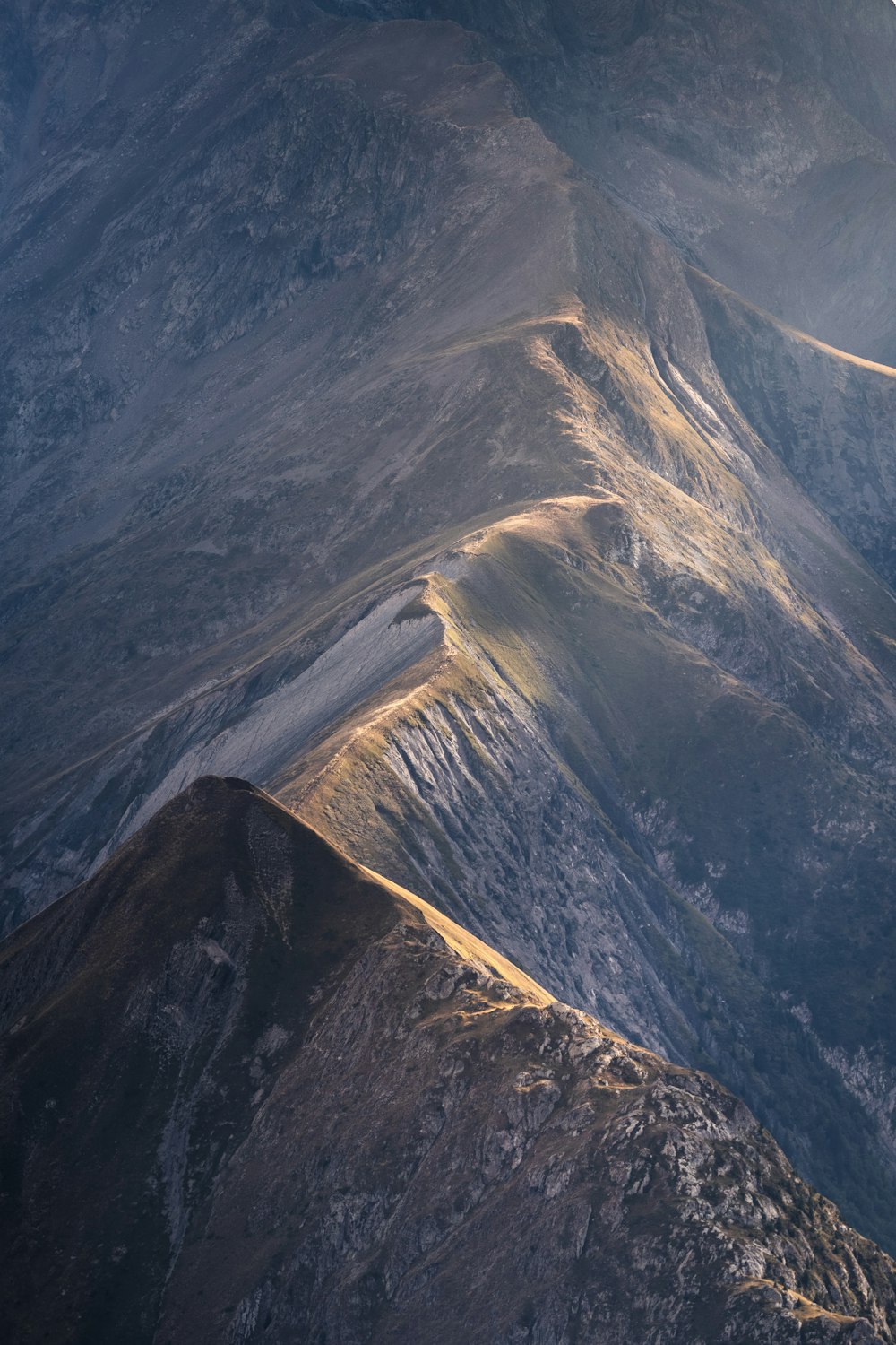 a large mountain with a river running through it