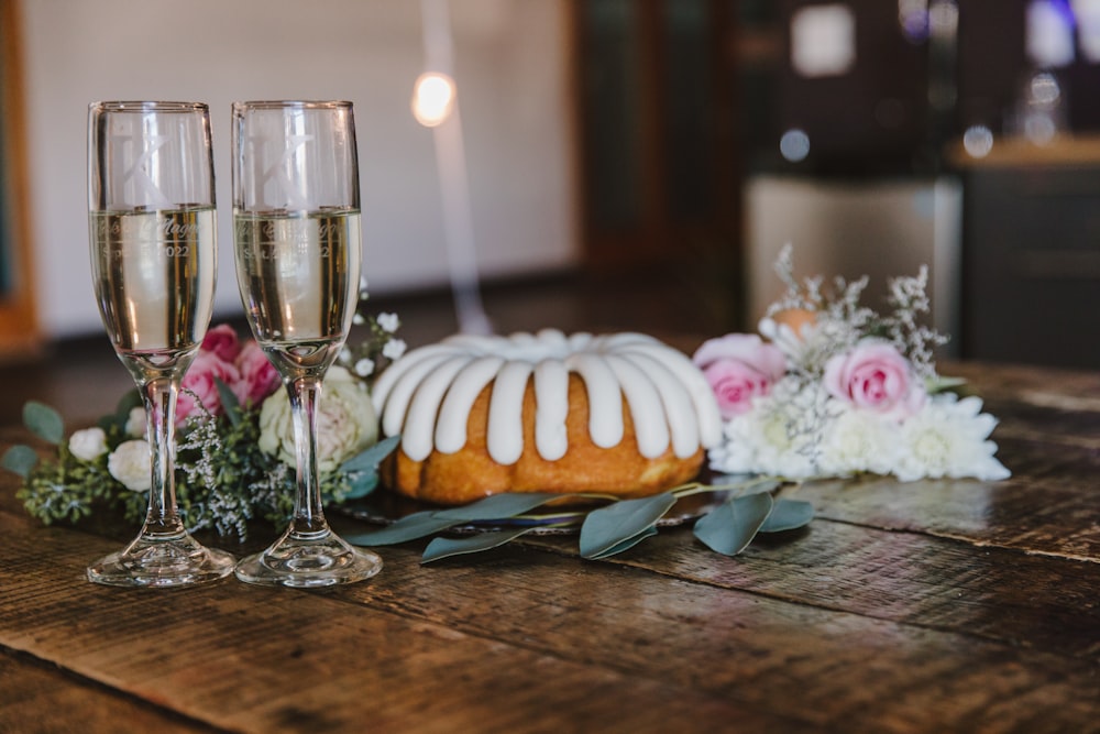 a cake and wine glasses on a table