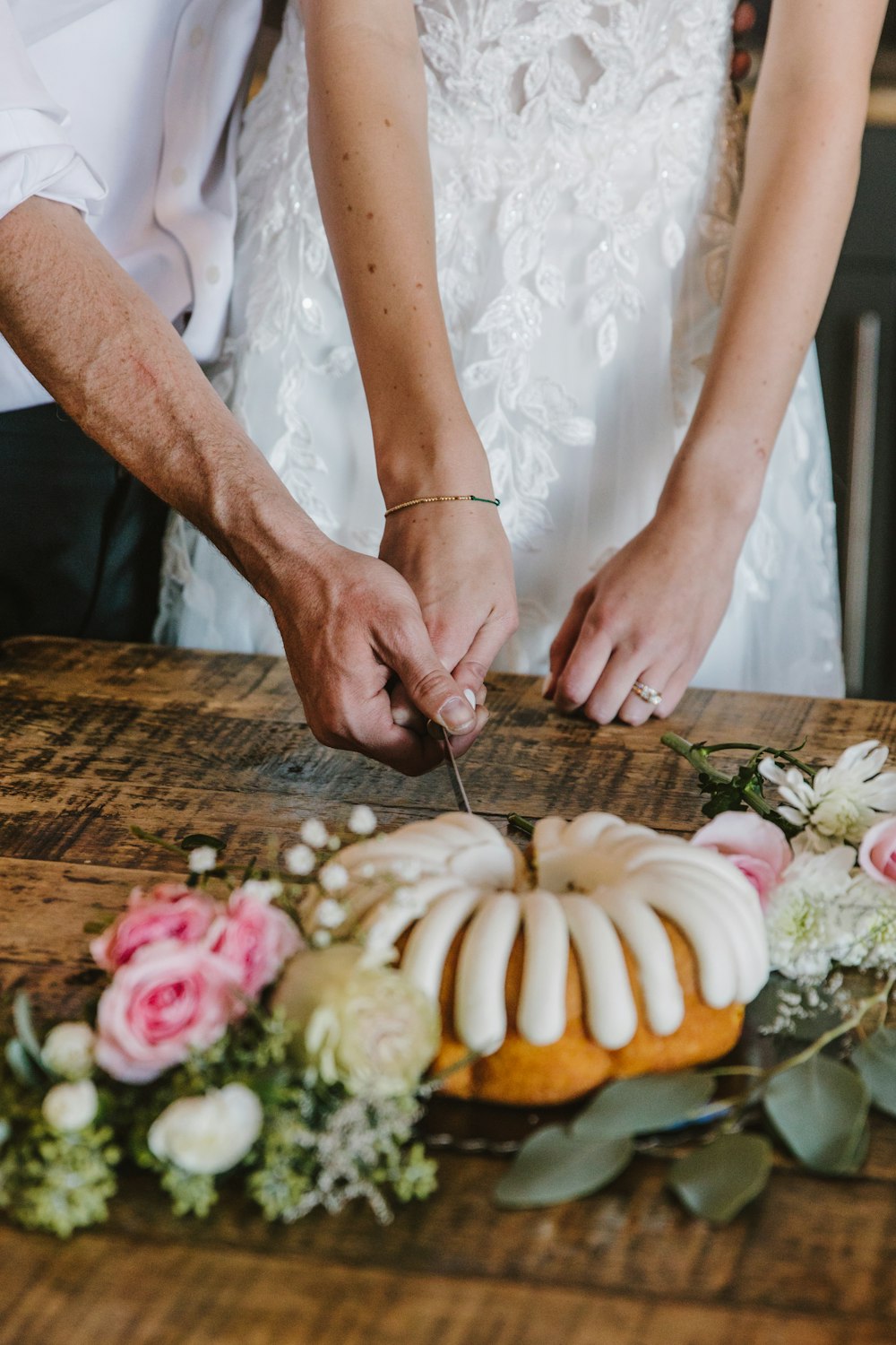 a bride and groom cutting a wedding cake