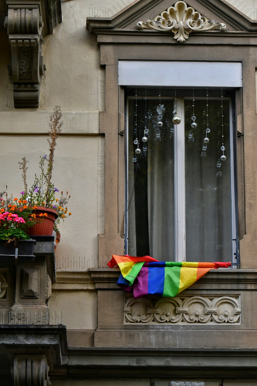 a rainbow flag from a window