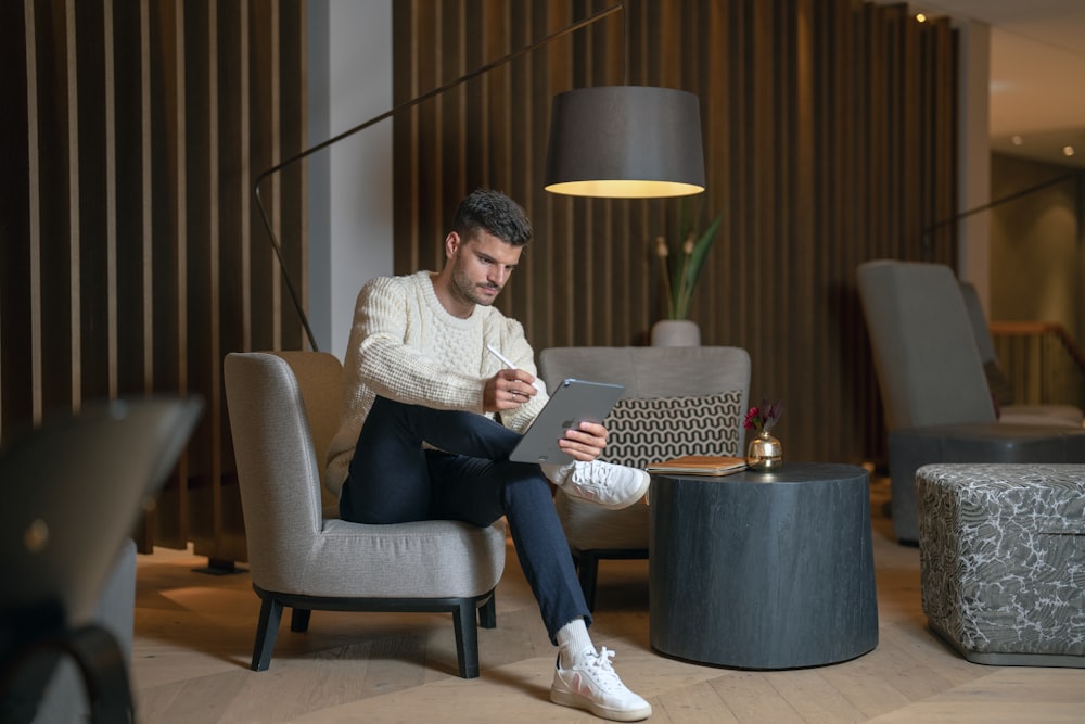 a person sitting in a chair with a laptop