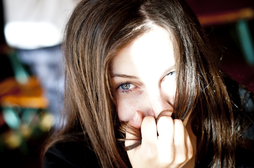 a woman with her hand on her face