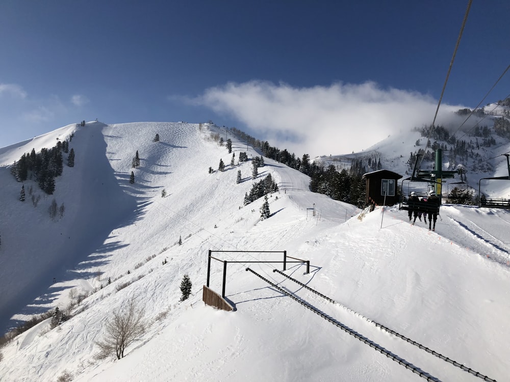 a ski lift going up a snowy mountain