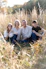 a group of people sitting in a grassy area