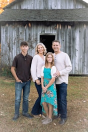 a group of people posing for a photo in front of a building