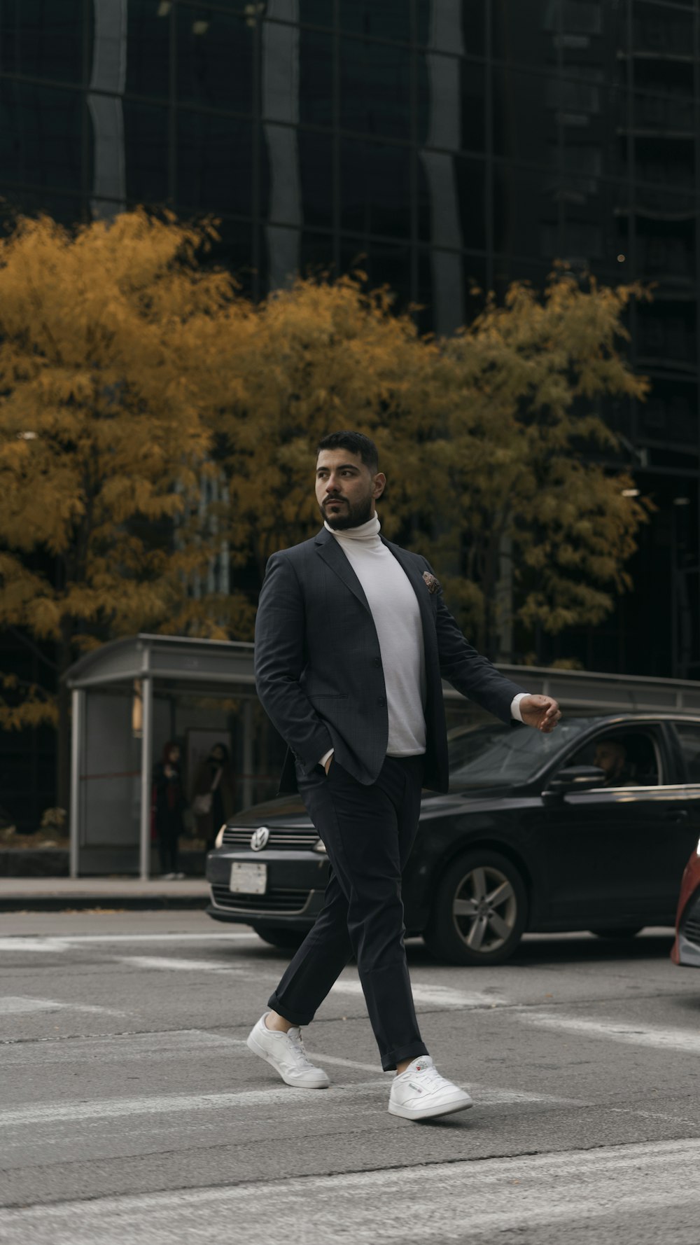 a person in a suit walking on a street