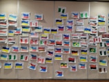 Students engaged in a cultural exchange workshop with flags and traditional items
