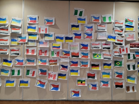 Students engaged in a cultural exchange workshop with flags and traditional items