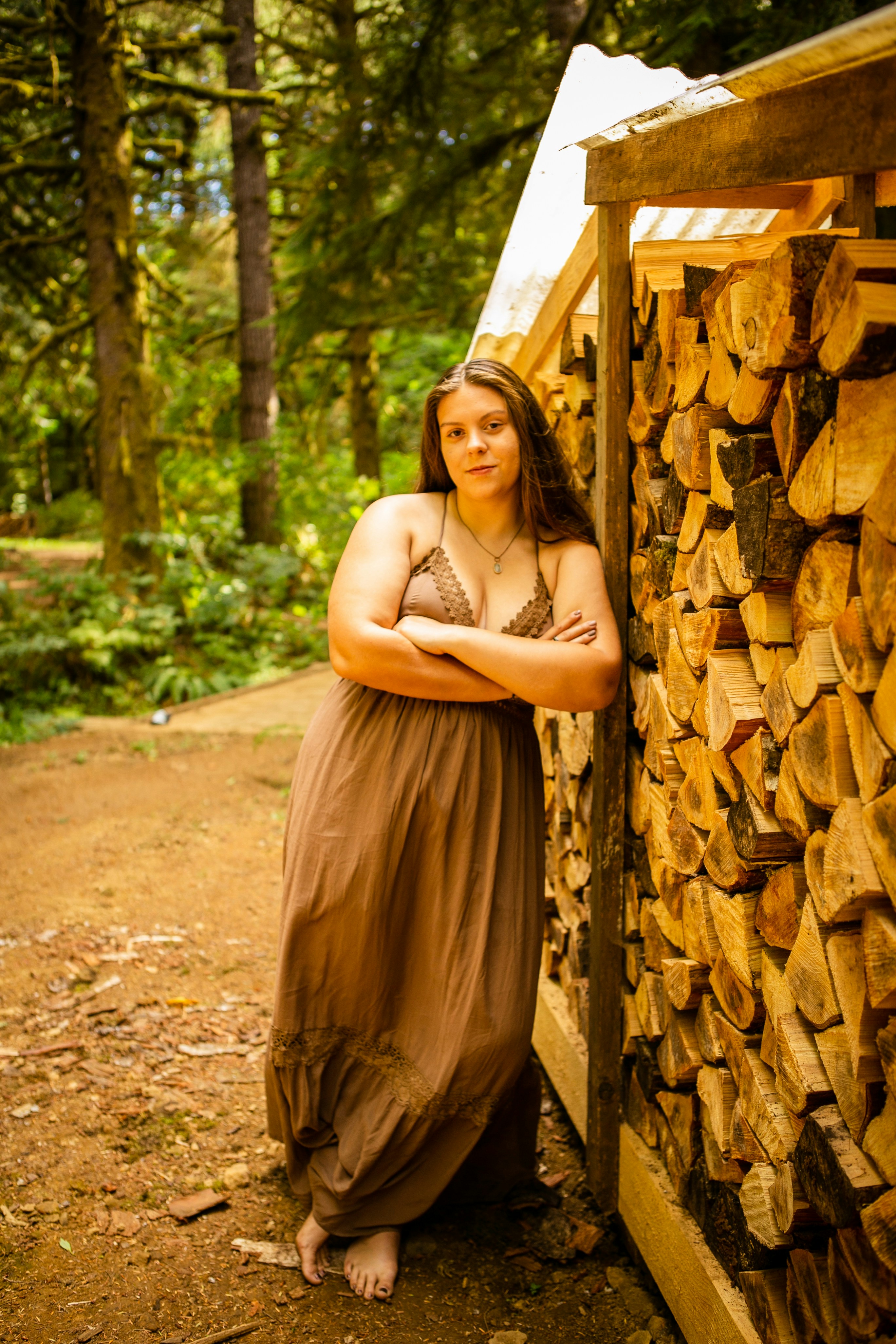 a person in a dress standing next to a wooden structure