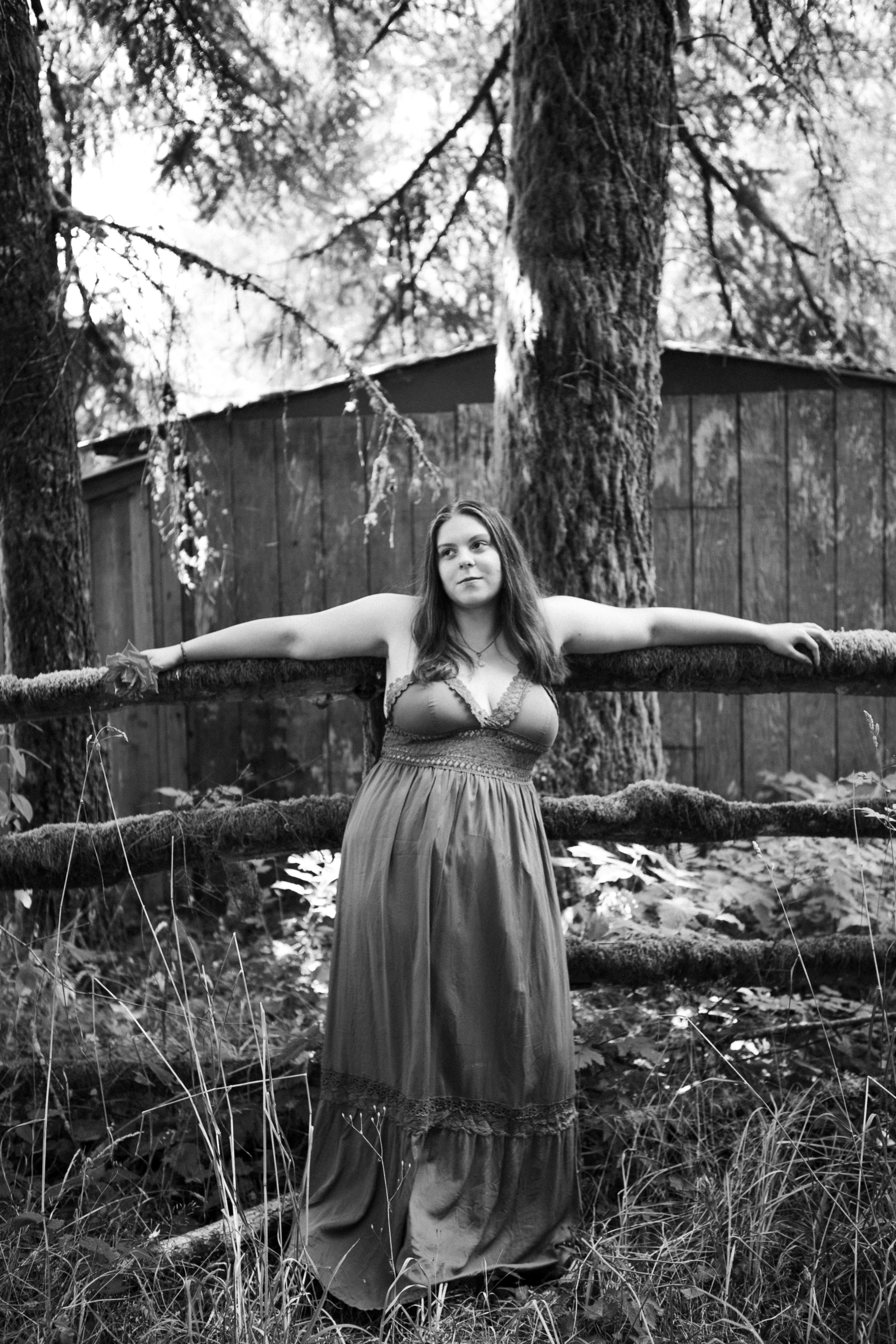 a person posing in front of a tree