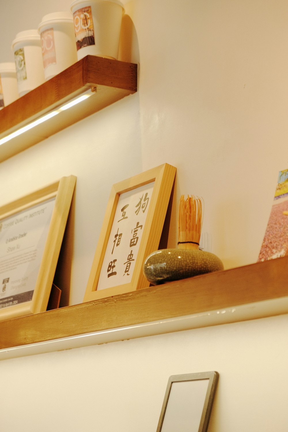 a shelf with a sign and a picture frame on it