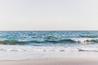 A serene landscape featuring a calm sea and gentle waves.