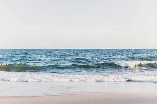 A serene landscape featuring a calm sea and gentle waves.