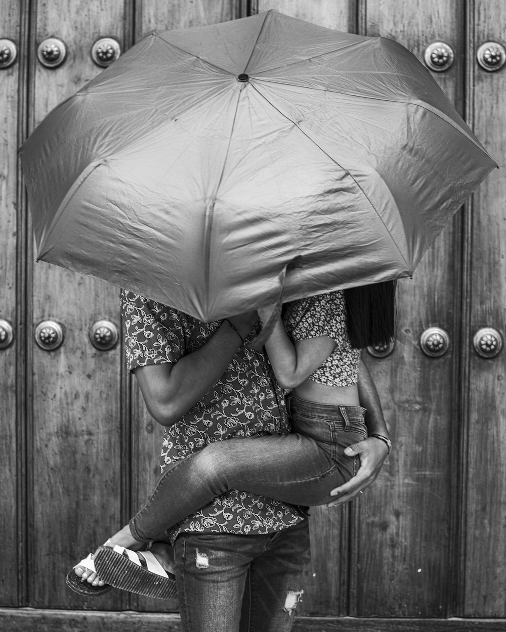 a woman sitting under an umbrella