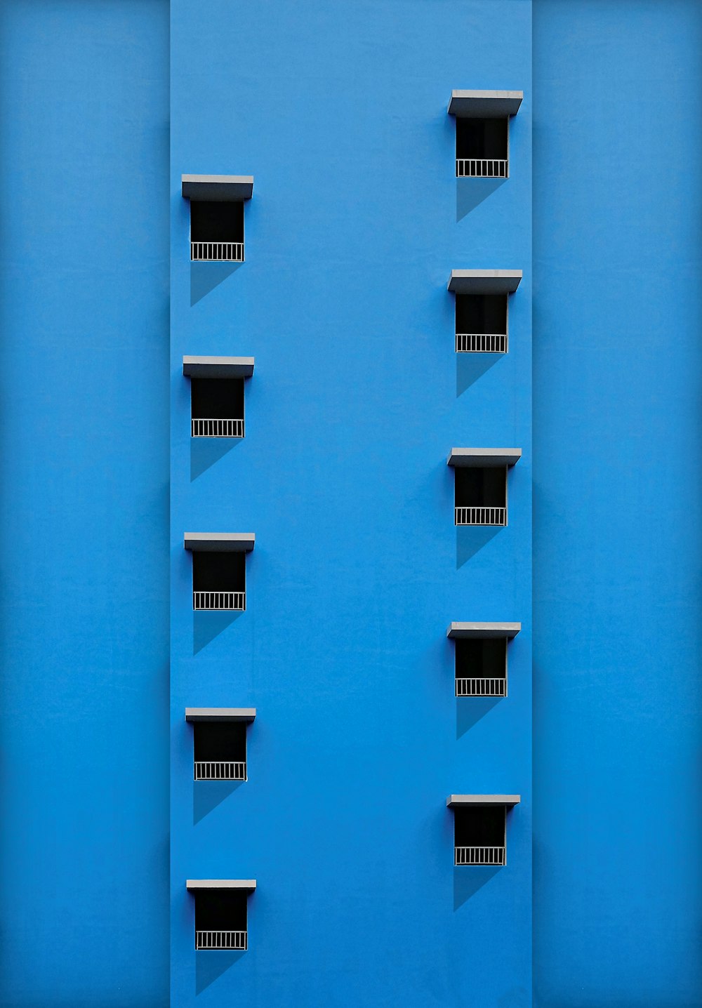 a blue wall with windows