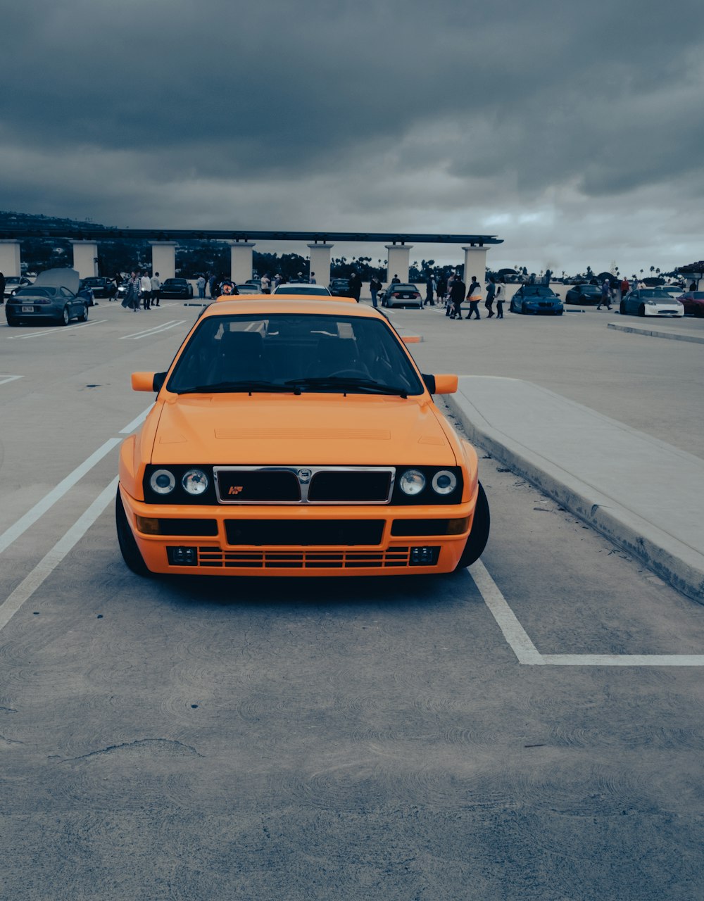 an orange car parked in a parking lot