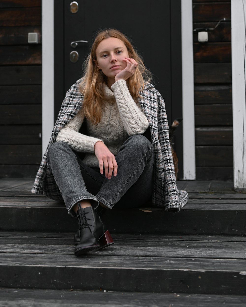 a woman sitting on a porch