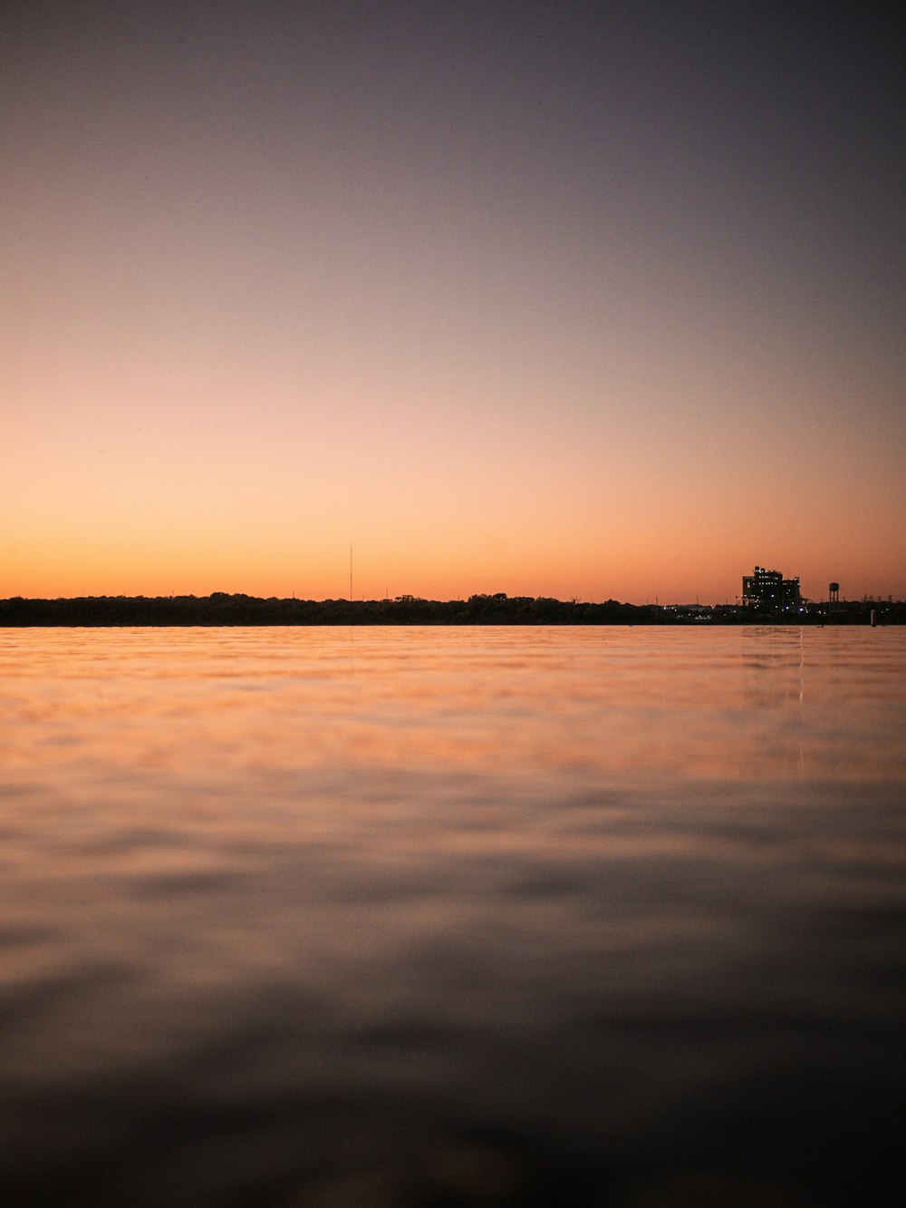 a body of water with a city in the distance