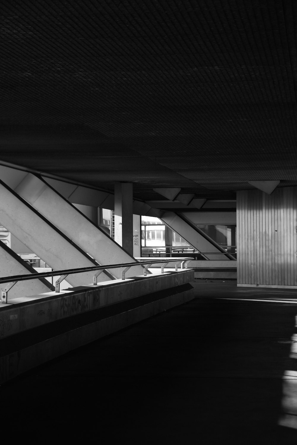 a black and white photo of a staircase in a building