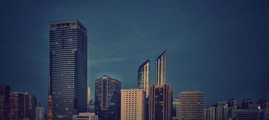 A sleek, minimalist office skyline at dusk evoking calm professionalism and global reach.