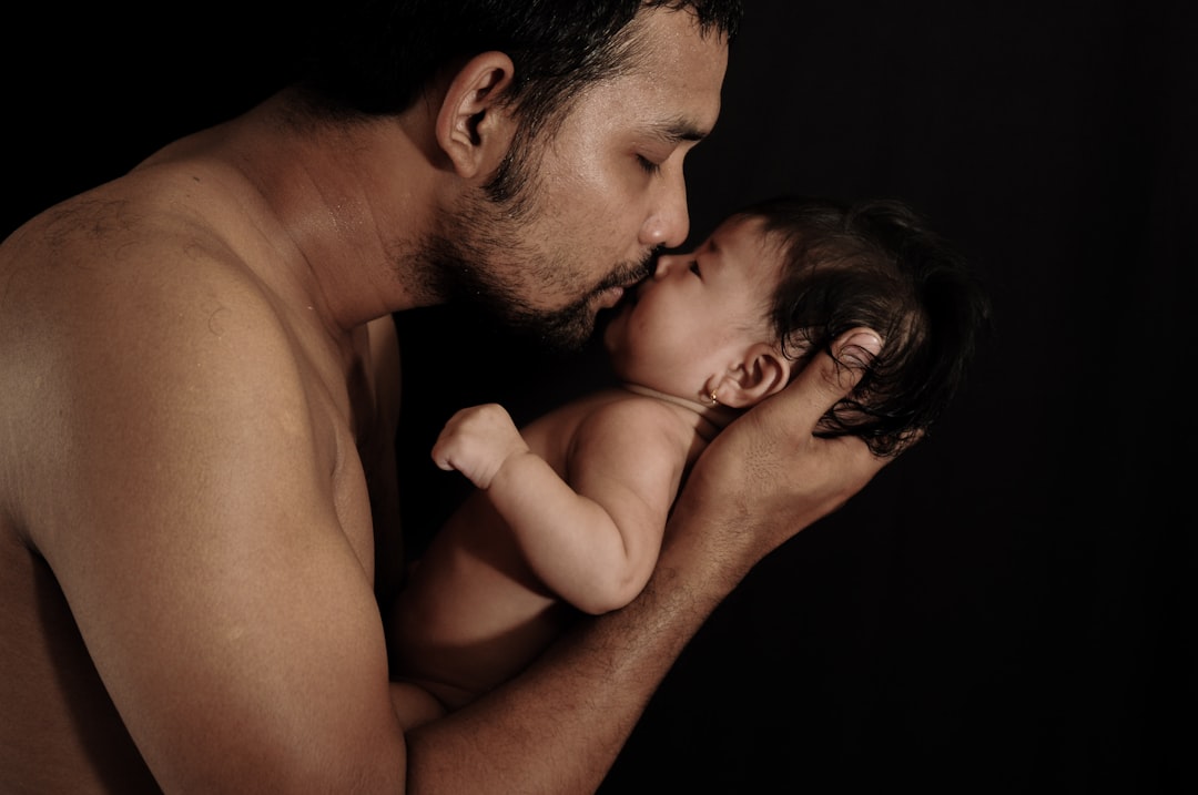a man and woman kissing, dad is my first love