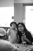 A smiling mother and child using a digital educational material together at home