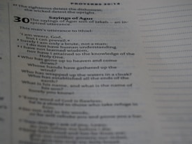 A photograph of a page from a book, showing text from Proverbs 30 in the Bible. The text is focused on the 'Sayings of Agur' with verses detailing reflections on weariness, understanding, wisdom, and rhetorical questions about divine power.