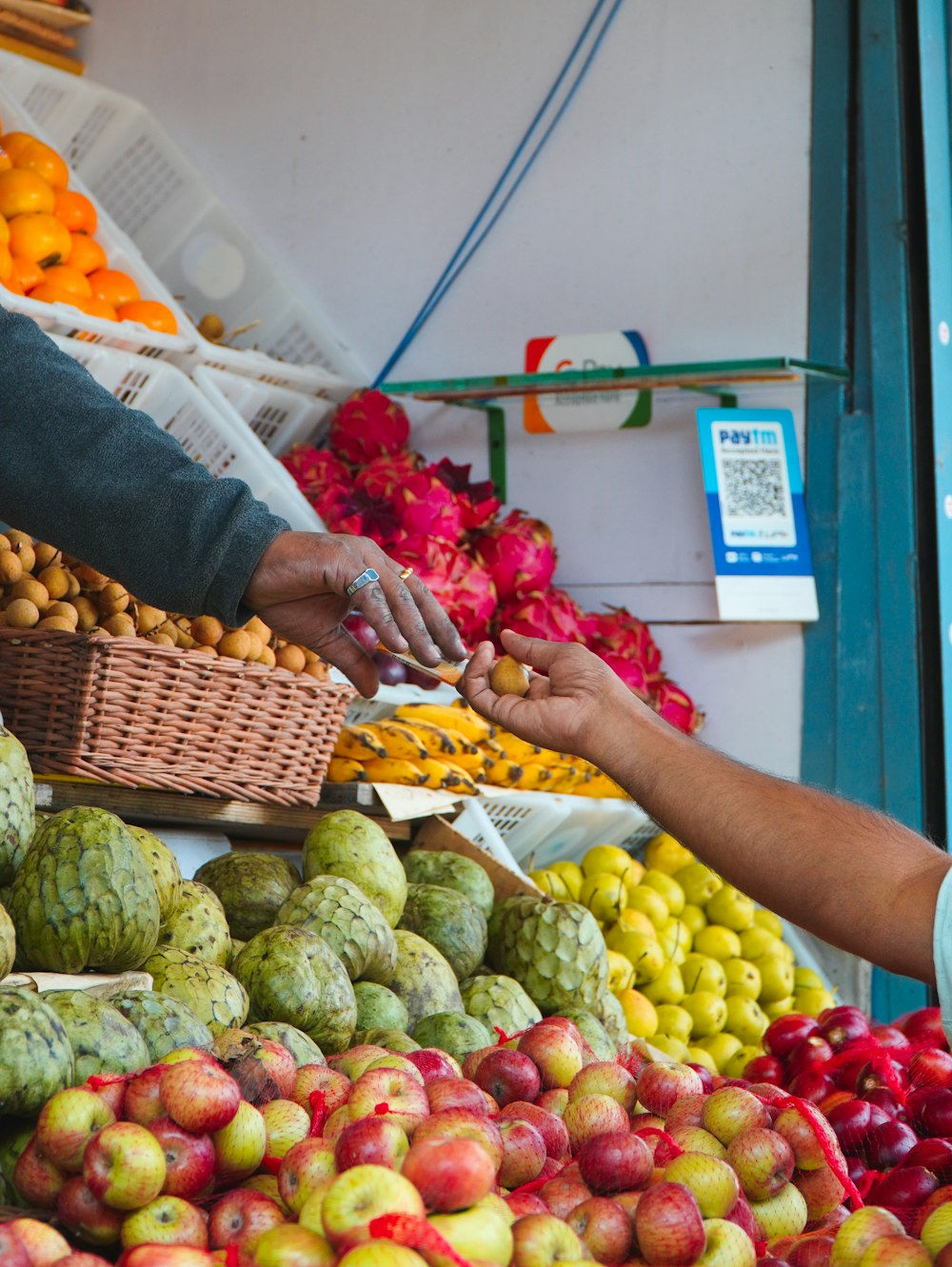 a person picking up a fruit