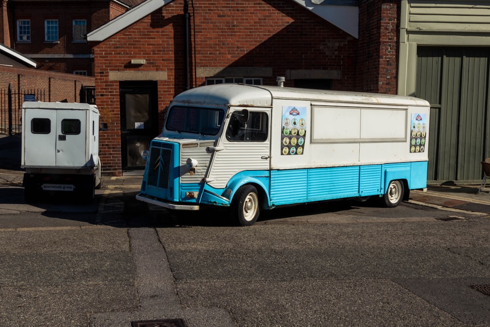 a blue truck parked next to a white truck