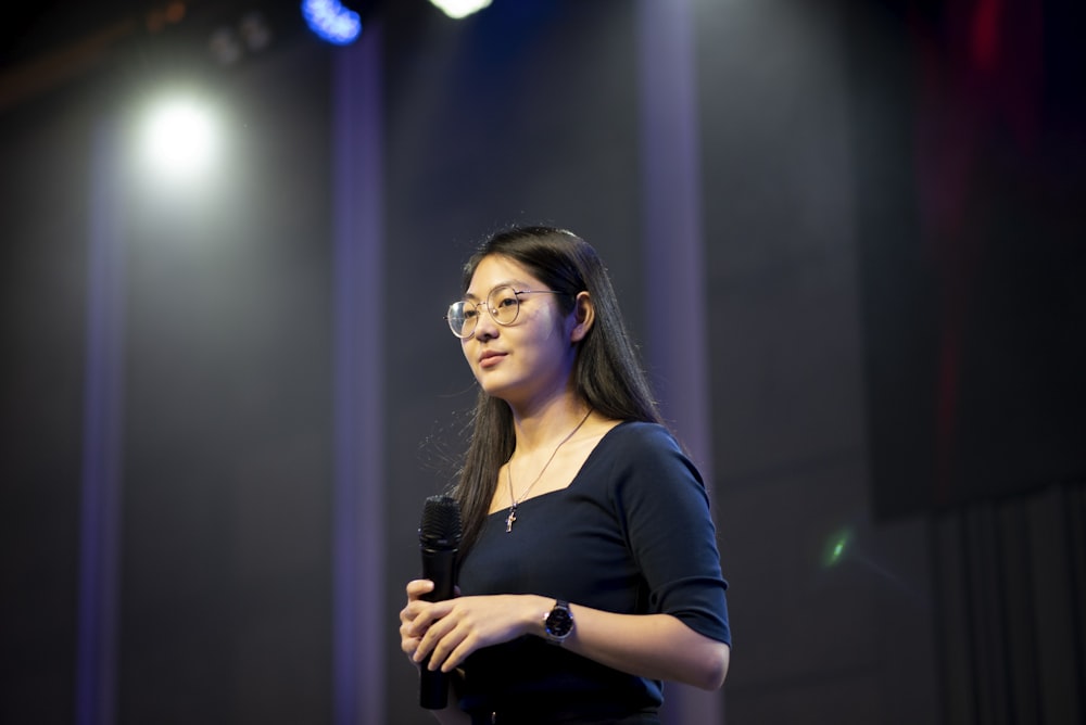 a woman speaking into a microphone