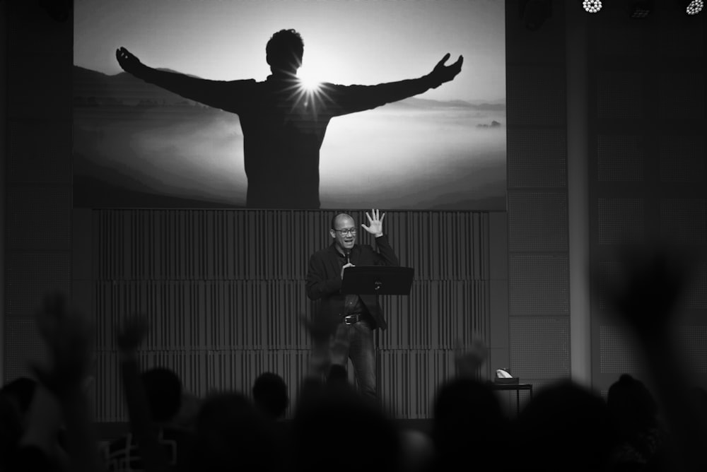 a man standing on a stage with a man holding a podium