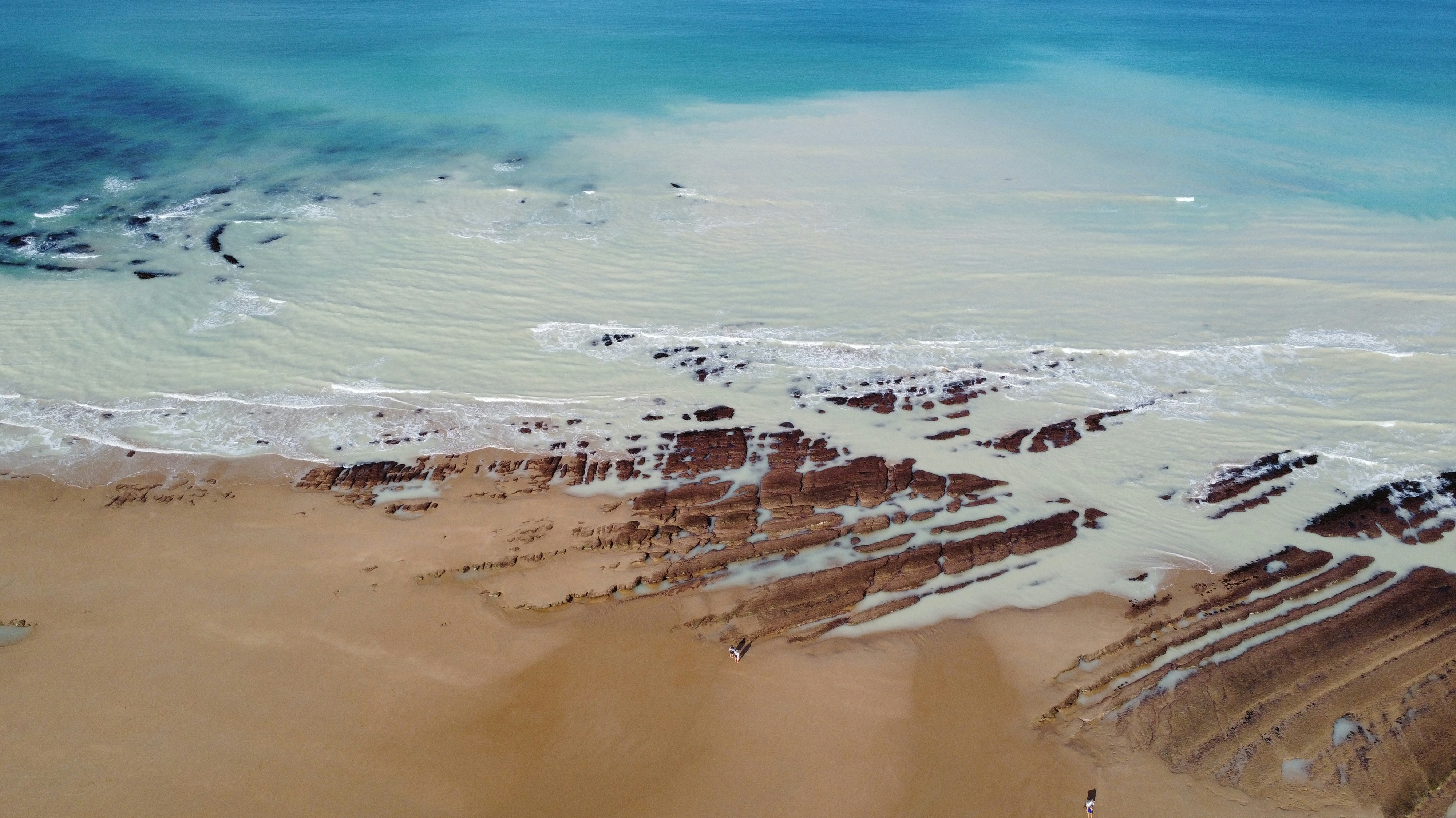 a beach with rocks and water