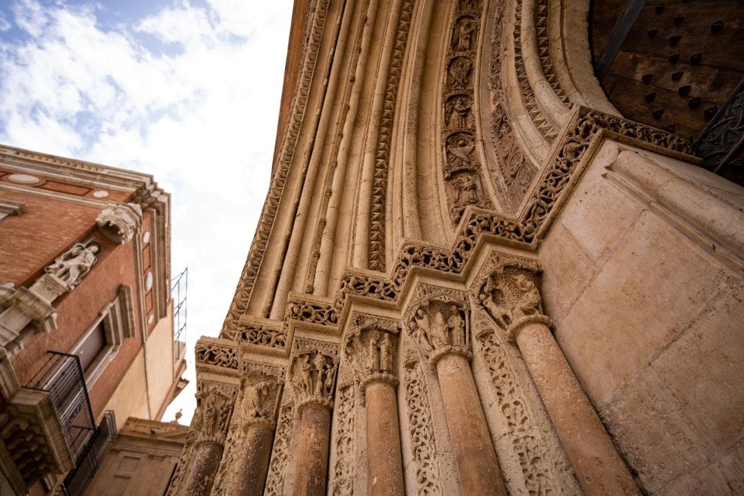a building with a large archway, Valencia Cathedral architectural details. If you used the photograph we would love if y