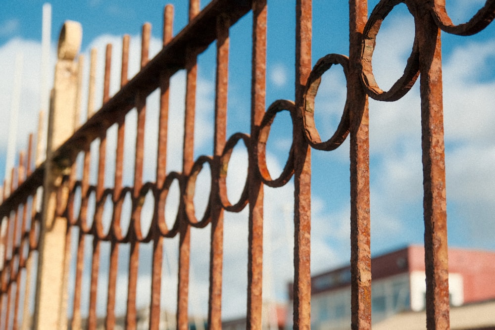 a fence with a building in the background