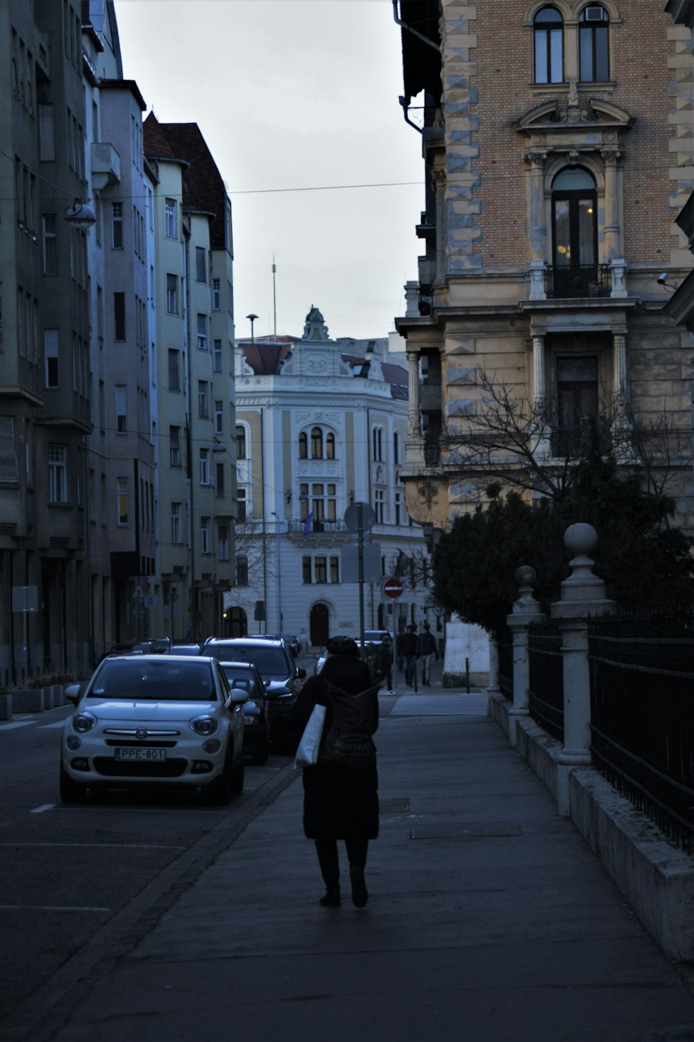 a person walking down a sidewalk