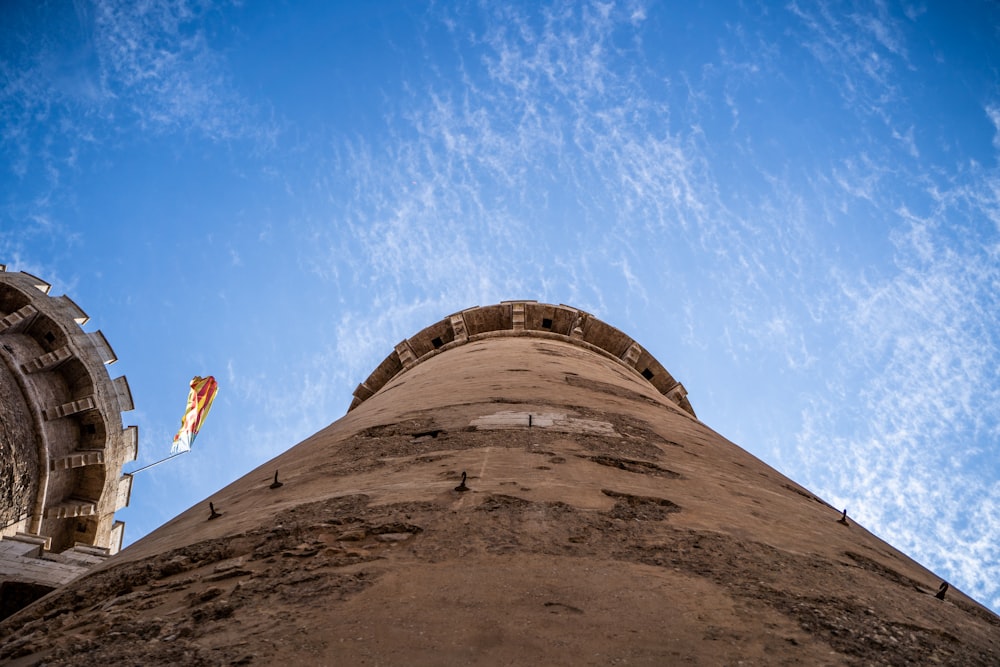 a flag flying in front of a large stone structure