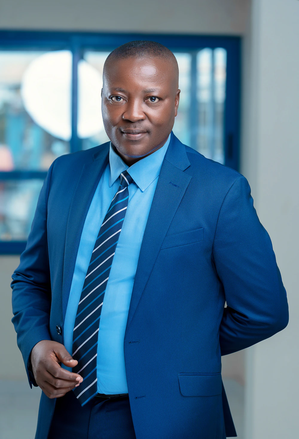 Nigerian professional in a blue shirt and tie