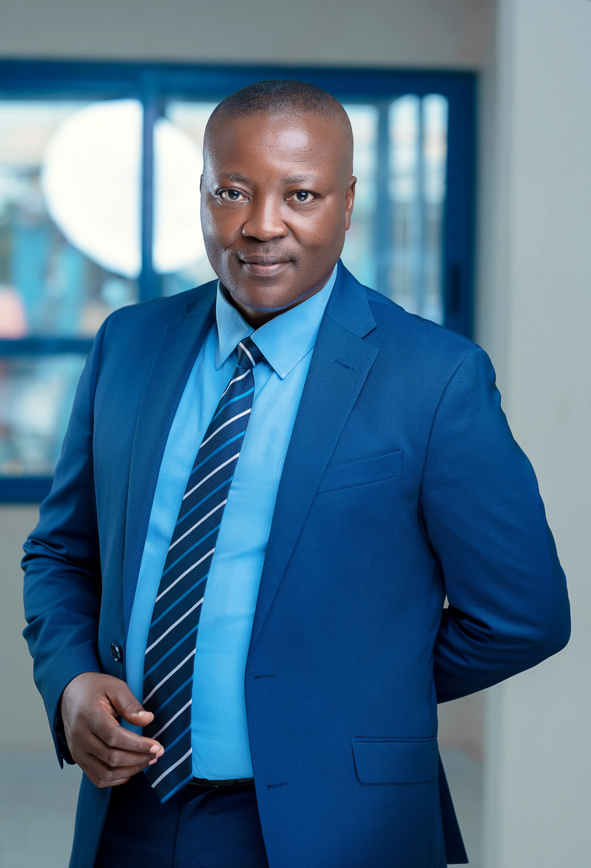 a man in a blue shirt and tie