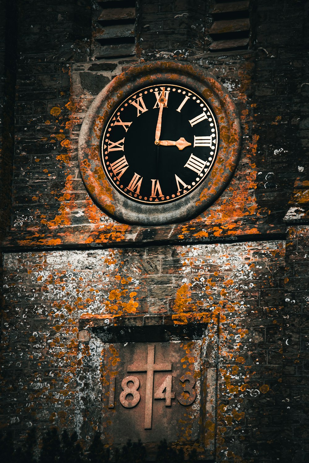 a clock on a brick wall