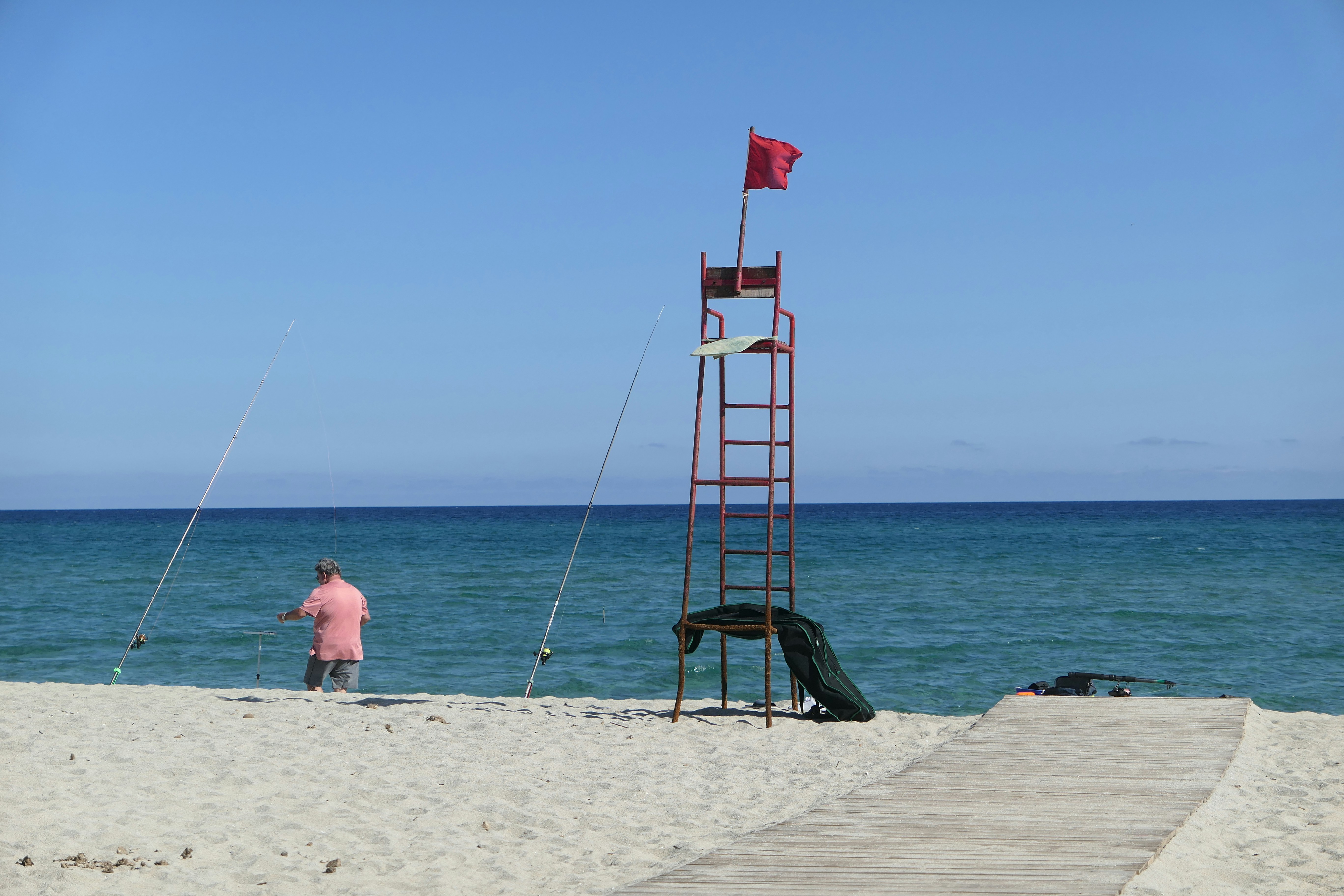 a person standing next to a tent on a beach