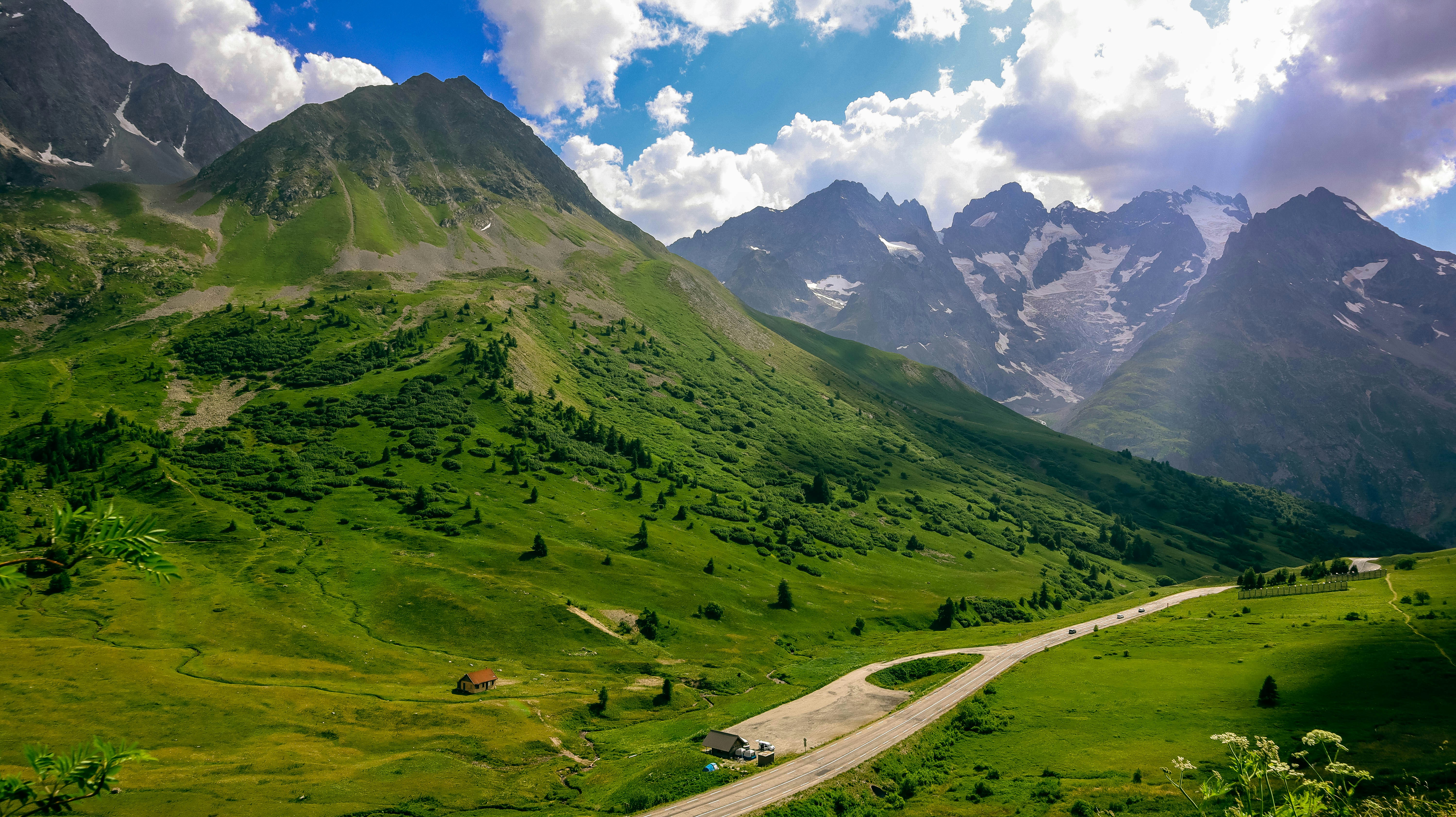 a road in a valley between mountains