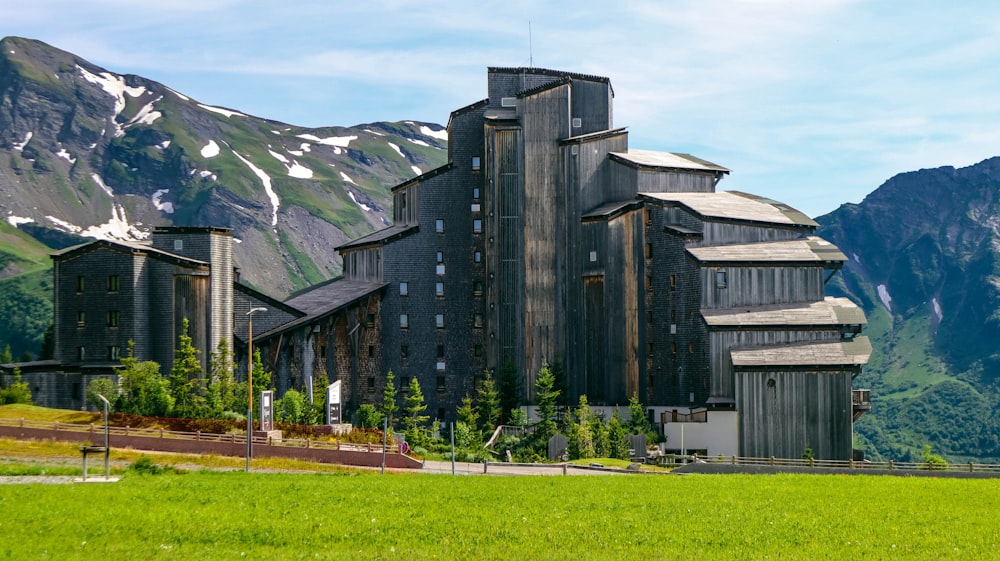 a large building with a mountain in the background