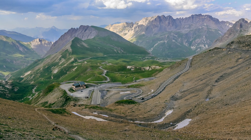 a road in a valley between mountains