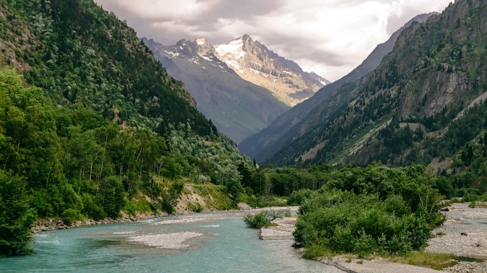 a river running through a valley between mountains